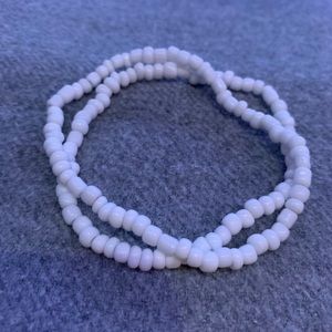A pair of white beaded bracelets.